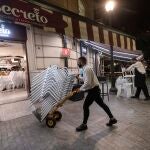 Dos camareros recogen las sillas de la terraza de un bar de la Plaza de Las Flores de Murcia. EFE/Marcial Guillén