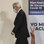 FILE - In this Dec. 24, 2020, file photo, Chilean President Sebastian Pinera walks away after observing the first vaccination shots for COVID-19 at the Metropolitan Hospital in Santiago, Chile. World leaders, including Pinera, are condemning the storming of the U.S. Capitol by supporters of President Donald Trump. (AP Photo/Esteban Felix, File)