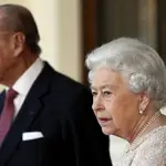 FILE - In this Thursday, Nov. 3, 2016 file photo, Britain's Prince Philip and Queen Elizabeth II bid farewell to Colombia's President Juan Manuel Santos, and his wife Maria Clemencia de Santos, following their state visit, at Buckingham Palace in London. Queen Elizabeth II and her husband have received their COVID-19 vaccinations. Buckingham Palace officials said in a statement that the 94-year-old monarch and 99-year-old Prince Philip received their jabs on Saturday, Jan. 9, 2021, joining some 1.5 million people in Britain who have been given the first dose of a vaccine against the coronavirus. (Stefan Wermuth/Pool Photo via AP, File)