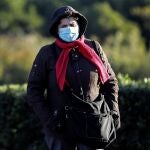 Una persona bien abrigada pasea esta mañana en Valencia