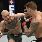 Jan 23, 2021; Abu Dhabi, United Arab Emirates; Conor McGregor of Ireland punches Dustin Poirier in a lightweight fight during the UFC 257 event inside Etihad Arena on UFC Fight Island. Mandatory Credit: Jeff Bottari/Handout Photo via USA TODAY Sports