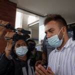 24 January 2021, India, Badung: Immigration officers escort Russian social media influencer Sergei Kosenko to the airport before being deported after he attended a party with 50 people and thus violating COVID-19 health protocols. Photo: Dicky Bisinglasi/ZUMA Wire/dpa24/01/2021 ONLY FOR USE IN SPAIN