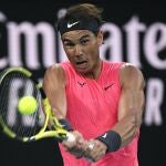 FILE - In this Jan. 29, 2020, file photo, Spain's Rafael Nadal makes a backhand return to Austria's Dominic Thiem during their quarterfinal match at the Australian Open tennis championship in Melbourne, Australia. No. 2 Rafael Nada â€“ Seeks his 21st Grand Slam singles title, which would break a tie with Roger Federer for the most won by a man. (AP Photo/Andy Brownbill, File)