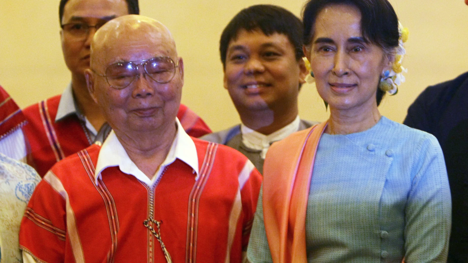 FILE - In this Aug. 24, 2016, file photo, then Myanmar's Foreign Minister Aung San Suu Kyi, right, and Mutu Say Po, chairman of Karen National Union (KNU) pose for photos during their meeting at a hotel in Naypyitaw, Myanmar days before a peace conference that seeks to end decades of armed conflict with ethnic minority groups. The future of the Myanmar’s already-fragile peace process between the military, ethnic armed groups and militias is in question as the military regains control of the country after Feb. 1, 2021 coup. (AP Photo/Aung Shine Oo, File)
