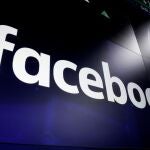 FILE - This March 29, 2018, file photo shows the Facebook logo on screens at the Nasdaq MarketSite, in New York's Times Square. Facebook said on Tuesday, Feb. 23, 2021, it lift its ban on Australians sharing news after a deal was struck on legislation that would make digital giants pay for journalism.(AP Photo/Richard Drew, File)