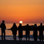 Arahama (Japan), 11/03/2021.- Local residents stand on the seashore at sunrise in Arahama, Miyagi prefecture, northeastern Japan, early 11 March 2021. Japan is commemorating the 10th anniversary of the Great East Japan Earthquake and subsequent tsunami in which approximately 20,000 people lost their lives on 11 March 2011. (Terremoto/sismo, Japón) EFE/EPA/JIJI PRESS JAPAN OUT EDITORIAL USE ONLY/ NO ARCHIVES