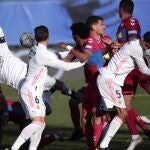 Real Madrid's Sergio Ramos, left, reacts next to Elche players during the Spanish La Liga soccer match between Real Madrid and Elche at the Alfredo di Stefano stadium in Madrid, Spain, Saturday, March 13, 2021. (AP Photo/Bernat Armangue)
