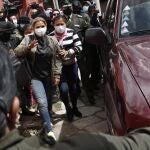 Bolivia's former interim President Jeanine ÃÃ±ez is escorted into a prison in La Paz, Bolivia, Monday, March 15, 2021. On Sunday a judge ordered ÃÃ±ez held for four months in preventative detention following her arrest on charges linked to the 2019 ouster of former President Evo Morales, which his supporters consider a coup dÃ©tat. (AP Photo/Juan Karita)