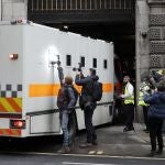 Journalists try to take pictures of the inside of a prison van moving into the Old Bailey, the Central Criminal Court in London, Tuesday, March 16, 2021. Serving British police officer Wayne Couzens stands accused of the kidnap and murder of 33-year-old Sarah Everard, who went missing while walking home in south London on March 3. (AP Photo/Frank Augstein)