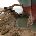 La excavadora retirando la arena junto al Ever Given aún encallado