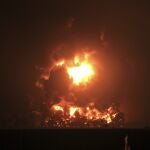 Night sky glows from a fire that razes through Pertamina Balongan Refinery in Indramayu, West Java, Indonesia, early Monday, March 29, 2021. Hundreds of people were evacuated from a nearby village after the massive fire broke out at the refinery. (AP Photo)