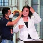 Peru's presidential candidate Keiko Fujimori of the Fuerza Popular party has her microphone adjusted as she prepares to participate in a presidential candidates debate, in Lima, Peru March 29, 2021. REUTERS/Sebastian Castaneda/Pool