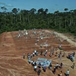 Relatives of people who died from COVID-19 gather next to a clandestine mass grave on the outskirts of Iquitos, Peru, Saturday, March 20, 2021. Local authorities approved the mass burials but never told the families, who believed their loved ones were interred in the nearby local cemetery â€” and only months later discovered the truth.Â (AP Photo/Rodrigo Abd)