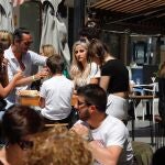 Varias personas disfrutan del día en la Plaza de las Flores de Murcia