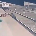 Momento en el que el empleado logra poner al niños a salvo en el andén