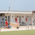 Varios trabajadores de la Cruz Roja en la Ciudad del Fútbol del Altos del Real , en Melilla, a donde fueron conducidos algunos de los últimos inmigrantes llegados a la ciudad Ángela Ríos / Europa Press18/05/2021