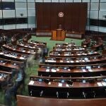 Pro-China lawmakers leave the chamber after the "Improving Electoral System (Consolidated Amendments) Bill 2021" was passed, at the Legislative Council in Hong Kong Thursday, May 27, 2021. Hong Kongâ€™s legislature on Thursday passed the bill amending electoral laws that drastically reduces the publicâ€™s ability to vote and increases the number of pro-Beijing lawmakers making decisions for the city. (AP Photo/Vincent Yu)