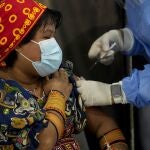 A healthcare worker gives a Guna Indigenous woman a shot of the AstraZeneca vaccine for COVID-19 at the Mega Mall on the outskirts of Panama City, Wednesday, June 9, 2021. On Wednesday, Panama began vaccinating women age 30 and older. (AP Photo/Arnulfo Franco)