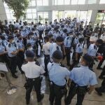 Police gather in the lobby of the Apple Daily headquarters in Hong Kong, Thursday, June 17, 2021. Hong Kong police on Thursday morning arrested the chief editor and four other senior executives of Apple Daily under the national security law on suspicion of collusion with a foreign country to endanger national security, according to local media reports. (Apple Daily via AP)