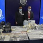 Senior Superintendent Li Kwai-wah, left, of Hong Kong Police National Security Department, and senior bomb disposal officer Alick McWhirter, right of Explosive Ordnance Disposal Bureau, pose with the confiscated evidence during a news conference as nine people were arrested over the alleged plot to plant bombs around Hong Kong, at the police headquarters in Hong Kong, Tuesday, July 6, 2021.(AP Photo/Kin Cheung)