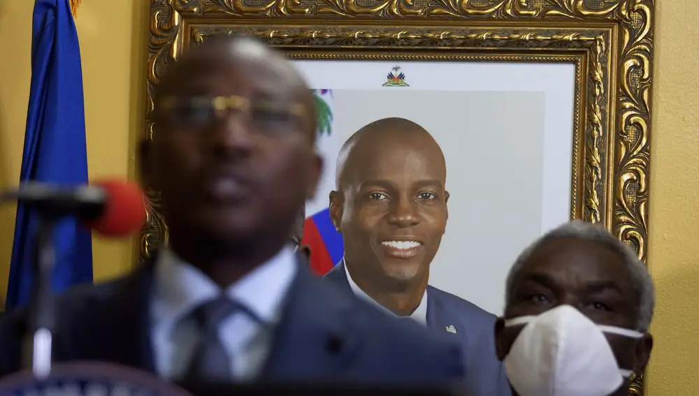 A picture of late Haitian President Jovenel Moise hangs on the wall of his former residence, behind interim Prime Minister Claude Joseph giving a press conference in Port-au-Prince, Tuesday, July 13, 2021. Authorities in Haiti on Thursday forcefully pushed back against reports that current government officials were involved in the July 7 killing of Haitian President Jovenel Moïse, calling them “a lie.†(AP Photo/Joseph Odelyn)