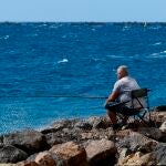 Un hombre pescando en un espigón