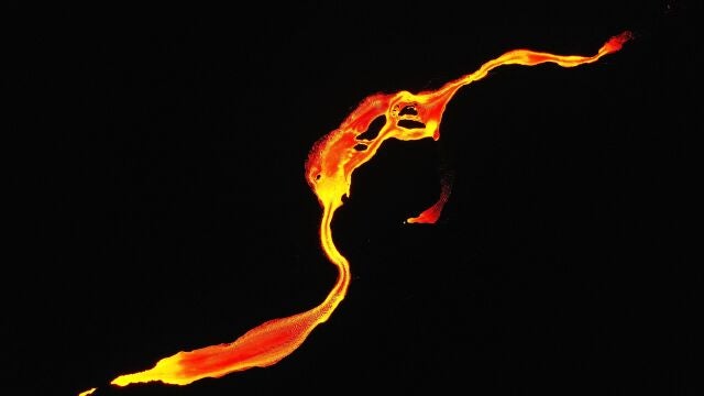 Fotografía realizada con un dron que muestra la colada de magma que se dirige al mar por la erupción del volcán Cumbre Vieja que vuelve a expulsar material solido este domingo