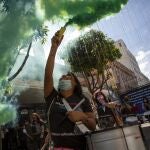 A woman waves a flare during a march marking the International Day for the Elimination of Violence Against Women, in Guatemala City, Thursday, Nov. 25, 2021. (AP Photo/Oliver de Ros)