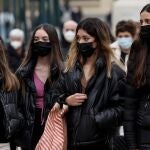 Varias personas caminan por la calle con mascarilla por las calles de Valencia