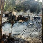 In this photo provided by the Karenni Nationalities Defense Force (KNDF), smokes and flames billow from vehicles in Hpruso township, Kayah state, Myanmar, Friday, Dec. 24, 2021. Myanmar government troops rounded up villagers, some believed to be women and children, fatally shot more than 30 and set the bodies on fire, a witness and other reports said Saturday. (KNDF via AP)