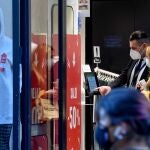 tarjeta verde para poder entrar en una tienda de ropa en Nápoles