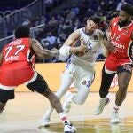 Rudy intenta superar la defensa de McKissic y Martin