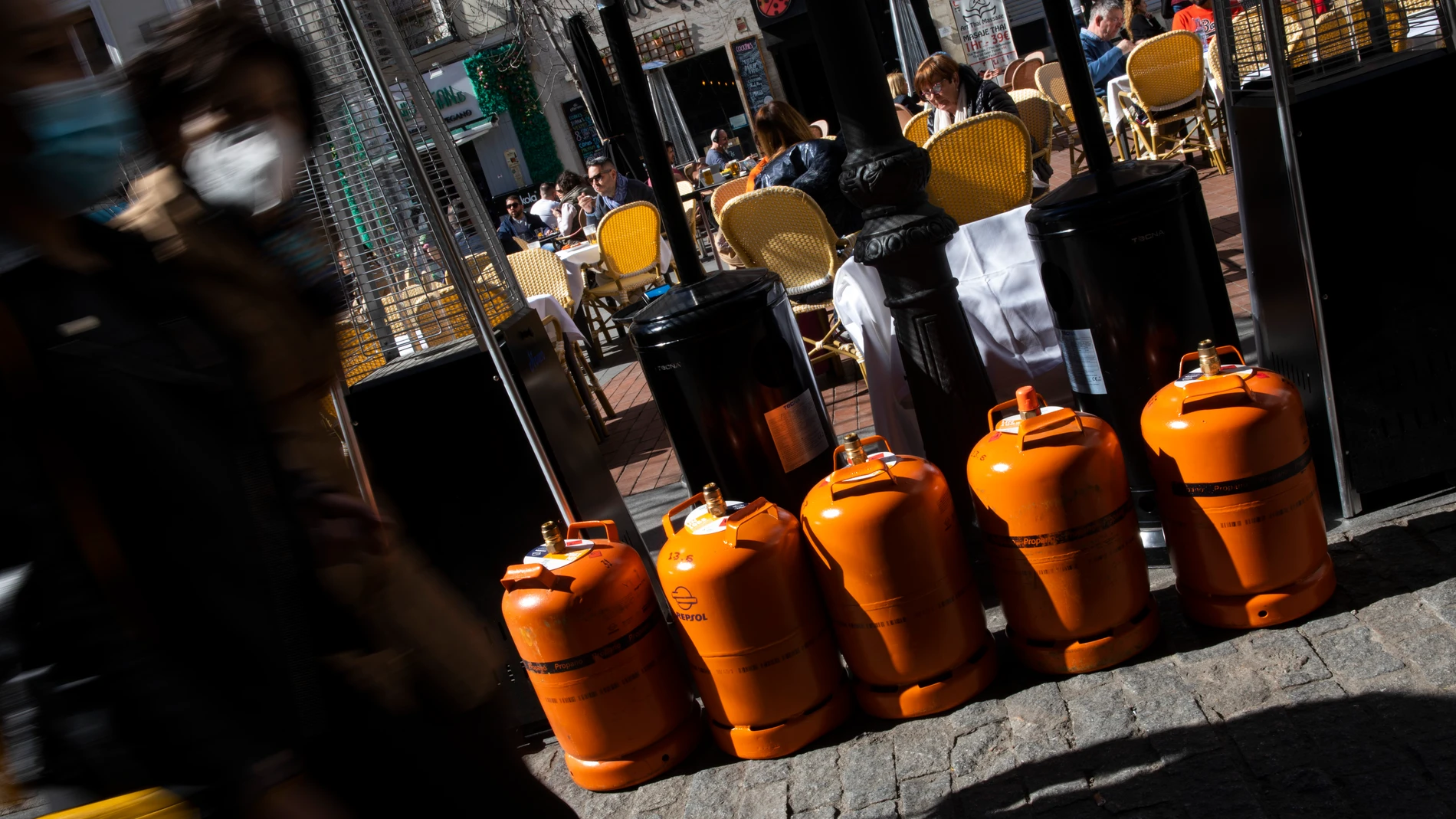 Unas bombonas de butano junto a unas estufas en una terraza de Madrid