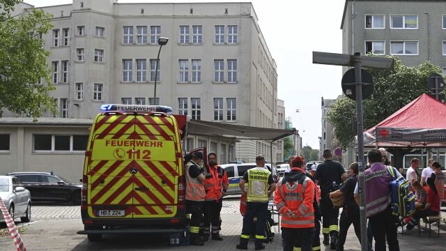 Emergency forces stand near a school in Bremerhaven, Germany, Thursday, May 19, 2022. German police say they have detained a suspect in connection with an attack at a high school in the northern city of Bremerhaven in which one person was injured. Police said the incident happened Thursday morning at the Lloyd high school in the center of the city. (Sina Schuldt/dpa via AP)