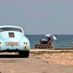 Varias personas toman el sol junto al mar, en La Habana