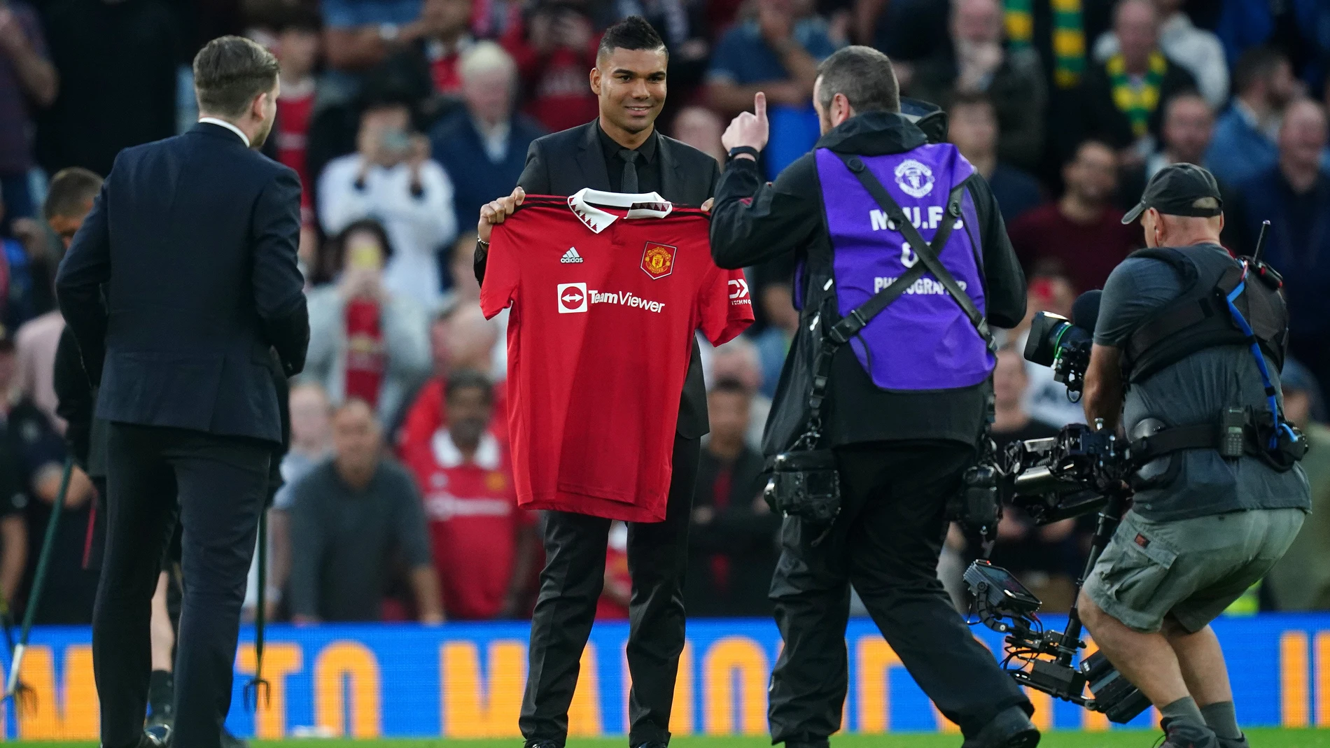 Casemiro posa con la camiseta del Manchester United sobre el césped de Old Trafford.