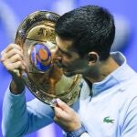 Serbia's Novak Djokovic poses with the trophy after winning the final tennis match of the ATP 500 Astana Open tennis tournament against Stefanos Tsitsipas of Greece in Astana, Kazakhstan, Sunday, Oct. 9, 2022. (AP Photo/Stas Filippov)