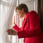 First Minister of Scotland Nicola Sturgeon waves to members of the public outside Bute House in Edinburgh after she announced her resignation during a press conference.