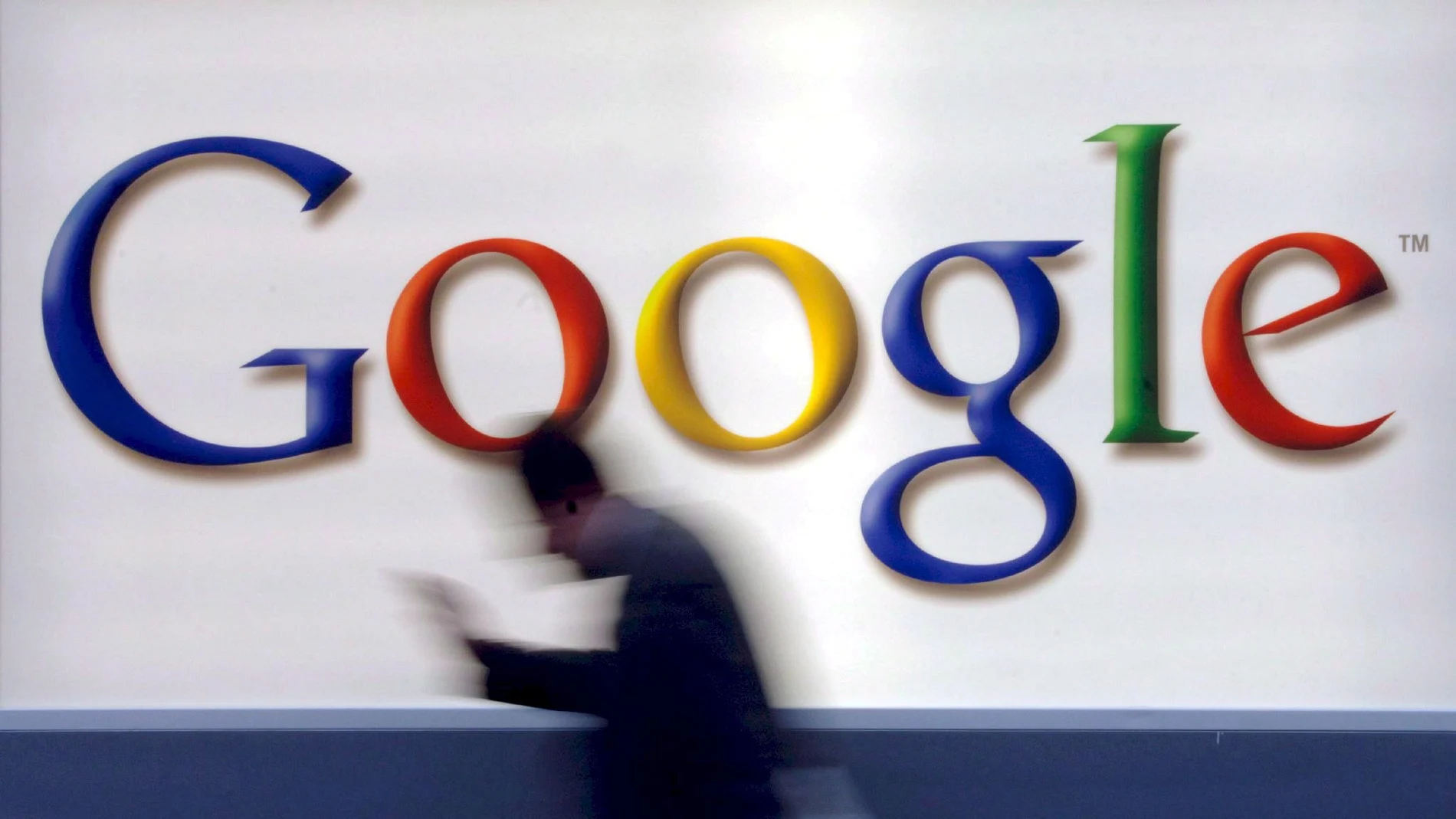 A man passes by a Google logo in Frankfurt, Germany,