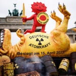 Greenpeace protests with giant dinosaur sculpture on day of nuclear power phase-out