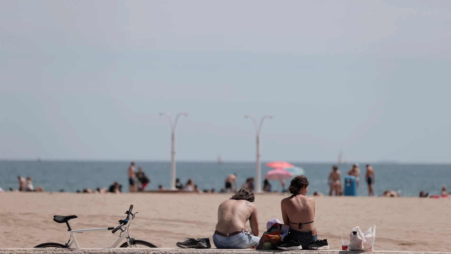 Imagen de archivo de varios jóvenes disfrutando del buen tiempo en la playa de la Malvarrosa en Valencia