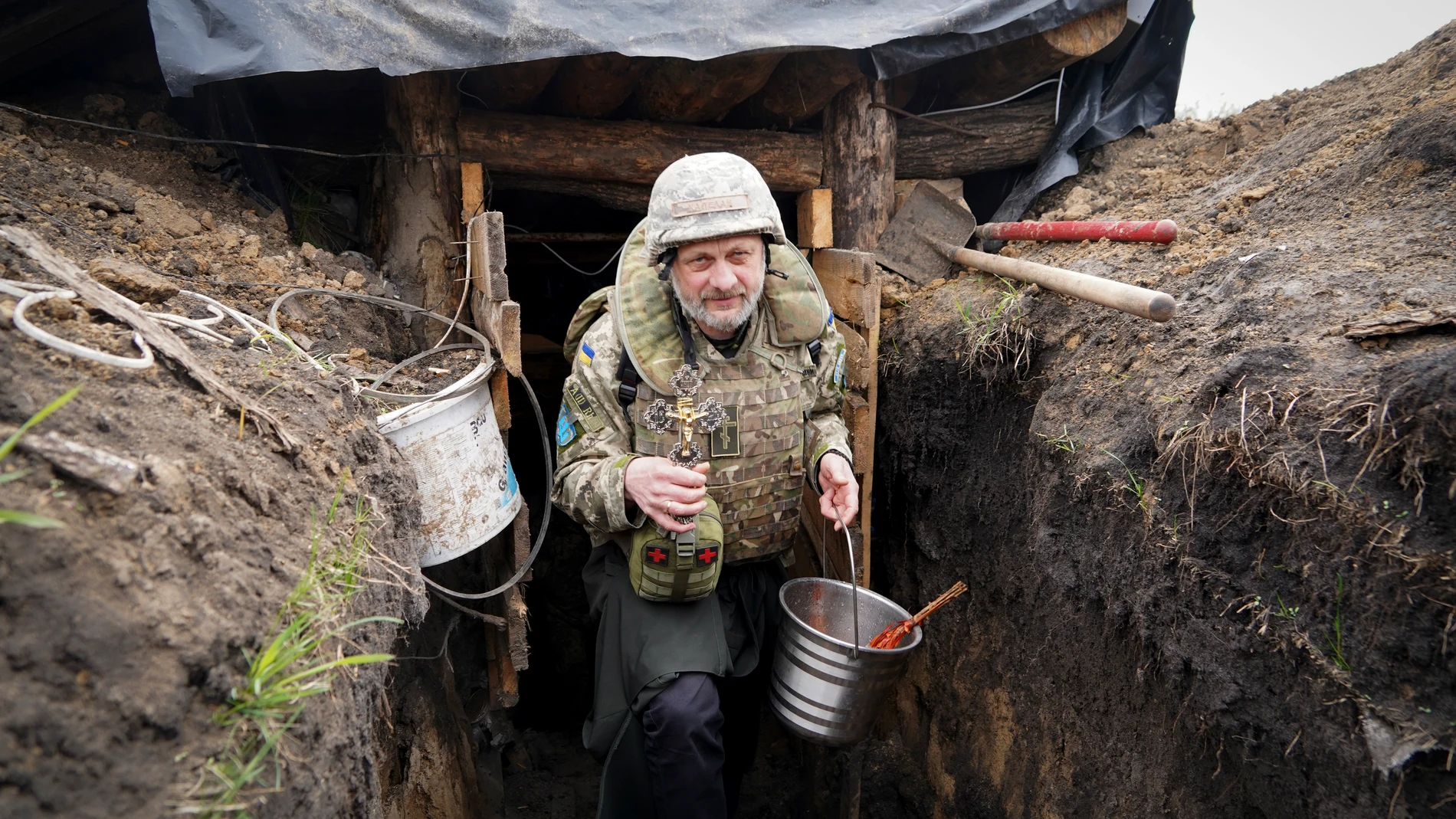A military chaplain visits Ukrainian positions on Orthodox Easter Eve near the frontline in the Kharkiv region, Ukraine, Saturday, April 15, 2023. (AP Photo/Andrii Marienko)