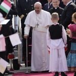 Pope Francis smiles as he arrives for the official welcome ceremony at Budapest's International Airport in Budapest, Hungary, Friday, April 28, 2023.