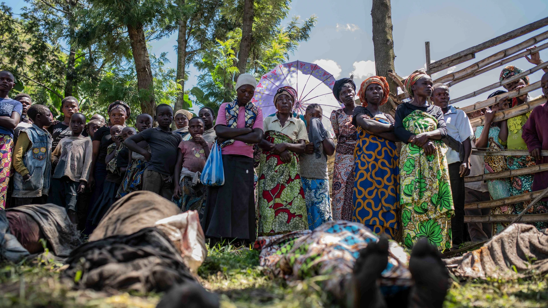Relatives gather to identify bodies in the village of Nyamukubi, South Kivu province, Congo, Saturday, May 6, 2023. The death toll from flash floods and landslides in eastern Congo has risen to over 150, with some 100 people still missing, according to a provisional assessment given by the governor and authorities in the country's South Kivu province. (AP Photo/Moses Sawasawa)