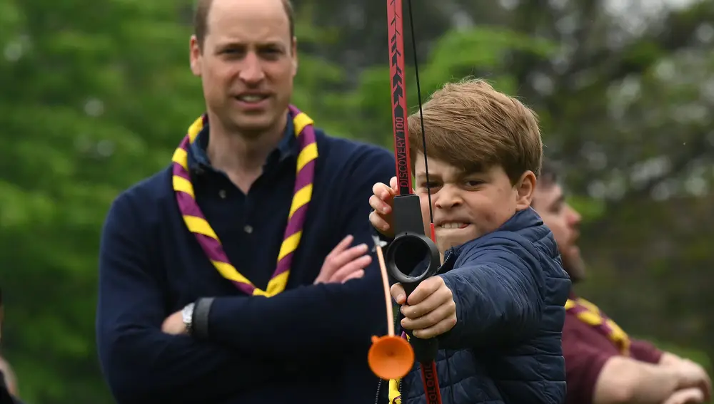 El príncipe George tira al arco, ante la mirada del príncipe de Gales