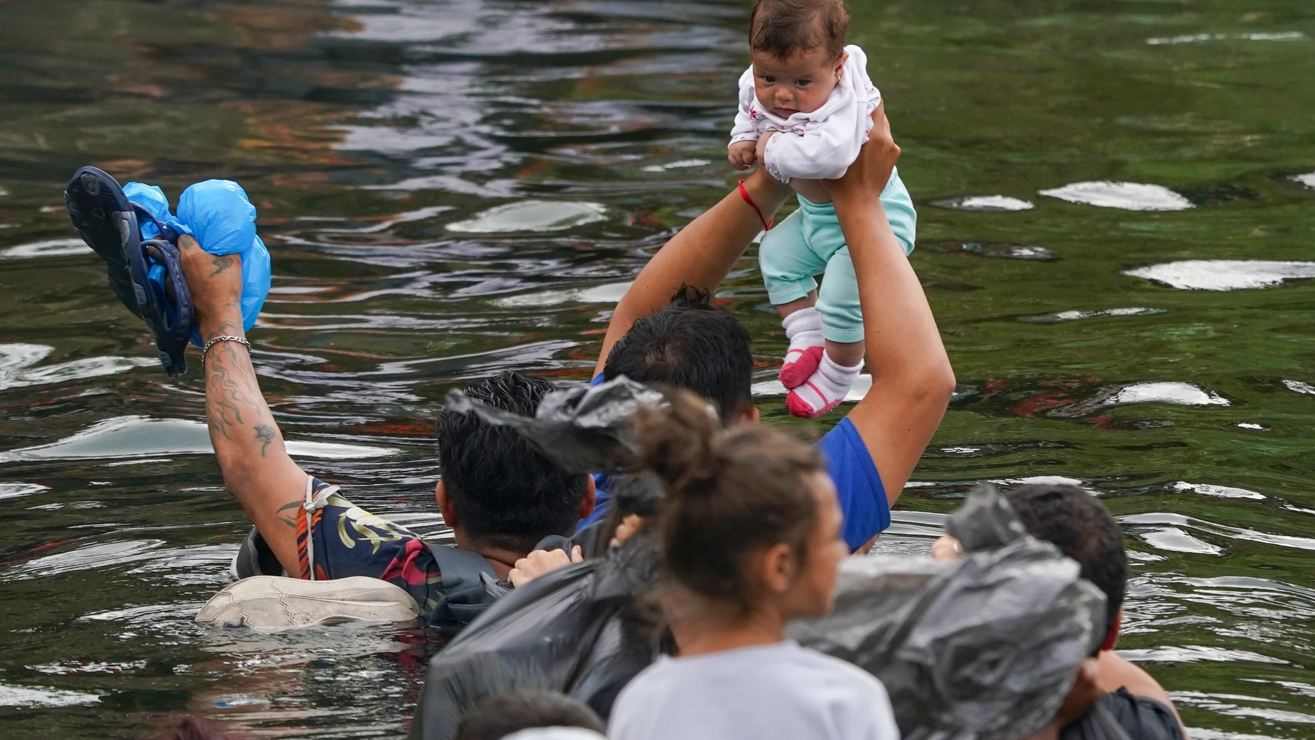 Migrants from El Salvador cross the Rio Grande river to the U.S. side, from Matamoros, Mexico, Thursday, May 11, 2023. Pandemic-related U.S. asylum restrictions, known as Title 42, are to expire May 11. (AP Photo/Fernando Llano)