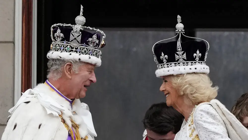 Britain's King Charles III and Queen Camilla smile on the balcony of Buckingham Palace after the coronation ceremony in London, Saturday, May 6, 2023.