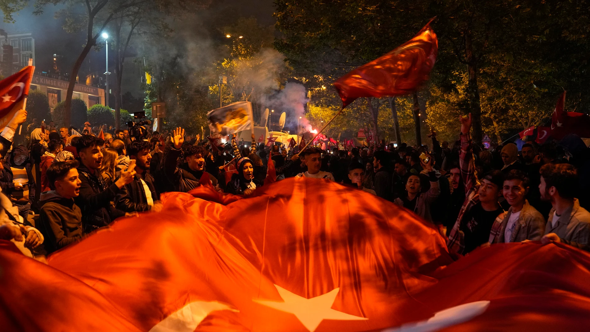 Supporters of President Recep Tayyip Erdogan cheer outside AKP (Justice and Development Party) headquarters in Istanbul, Turkey, Sunday, May 14, 2023. More than 64 million people, including 3.4 million overseas voters, were eligible to vote. (AP Photo/Khalil Hamra)