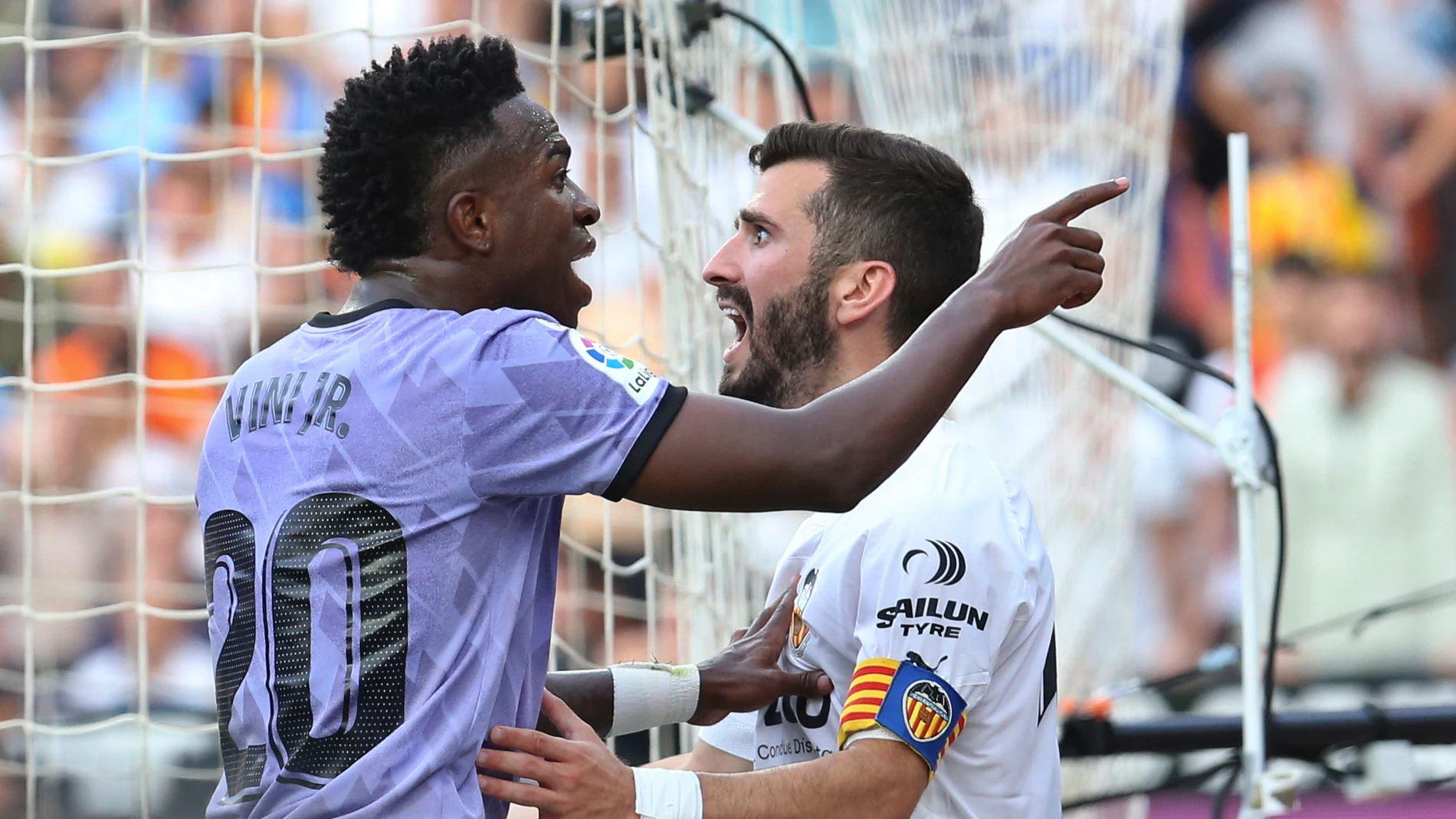 FILE - Real Madrid's Vinicius Junior, left, confronts Valencia fans standing in front of Valencia's Jose Luis Gaya during a Spanish La Liga soccer match between Valencia and Real Madrid, at the Mestalla stadium in Valencia, Spain, Sunday, May 21, 2023. Repeated racist insults against Brazilian soccer star Vincius Junior have unleashed a heated debate in Spain about tolerance for racism in a society that is becoming rapidly more diverse on and off the field. (AP Photo/Alberto Saiz, File)