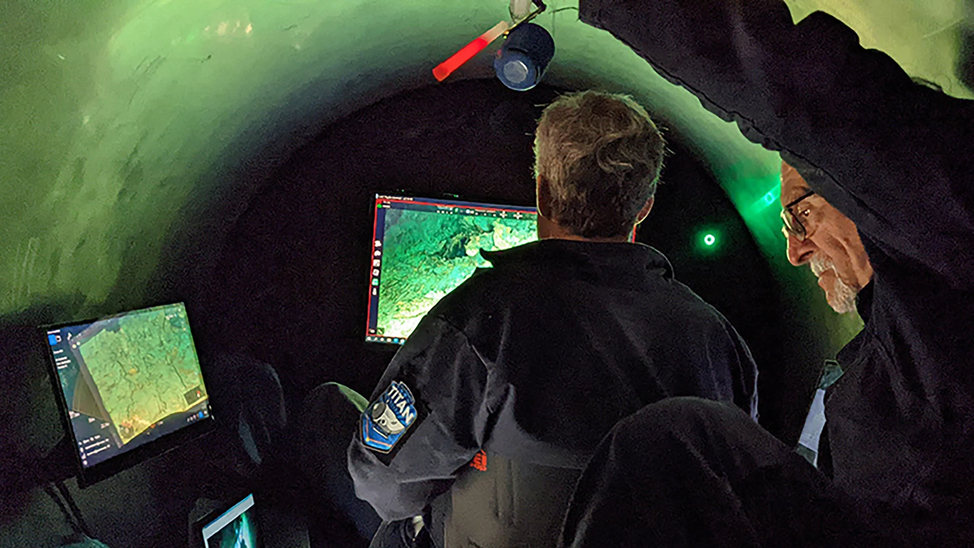 An undated handout photo released by OceanGate Expeditions shows employees working inside the submersible "Titan" used to visit the wreck site of the Titanic. Rescuers searching for a tourist submersible near the Titanic wreck in the North Atlantic have heard "noises" in the area near where the vessel went missing on Sunday.
